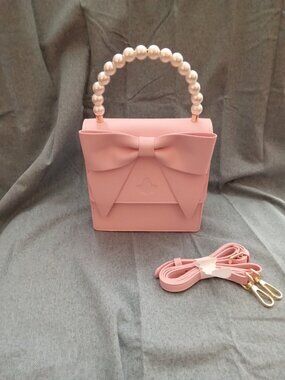 Beautiful pink pearl handle clutch purse with a attachable strap